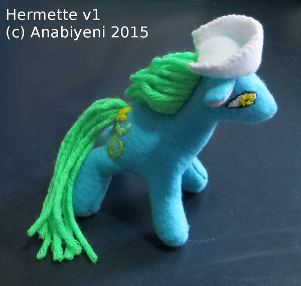 Plush blue pony with nurse's hat and symbol